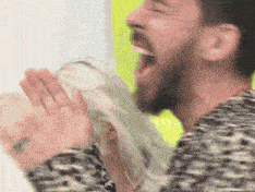 a man with a beard is screaming with his mouth open