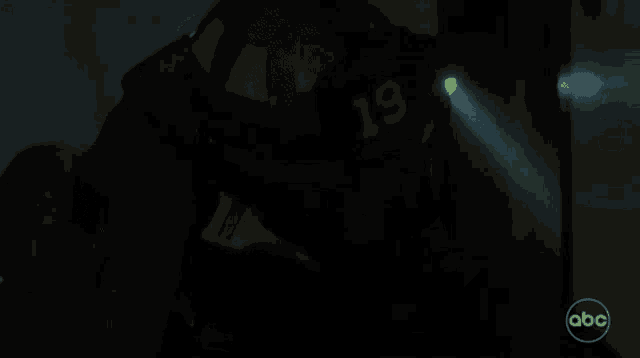 a close up of a person in a dark room holding a pen .