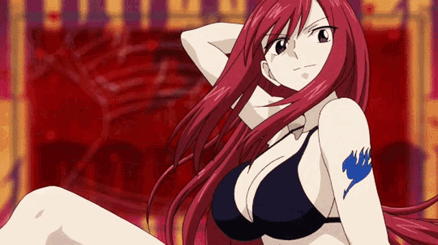 a girl with red hair is wearing a black bikini and has a blue fairy tail tattoo on her arm