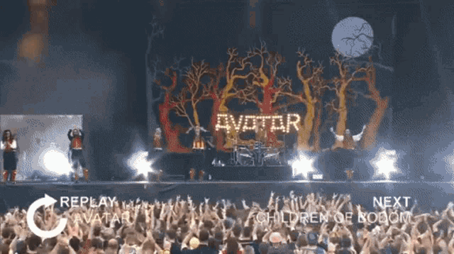 a group of people are standing in front of a stage that says avatar on it
