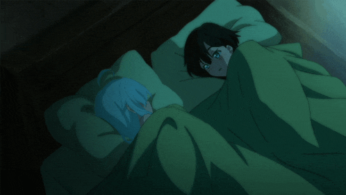 a man and a woman are sleeping in a bed with green blankets