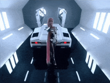 a woman with long pink hair is standing next to a white car
