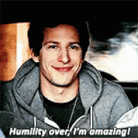 a man in a grey hoodie is smiling and saying humility over , i 'm amazing !