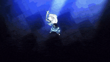 a man is holding a sword in a dark room with a light shining on him .