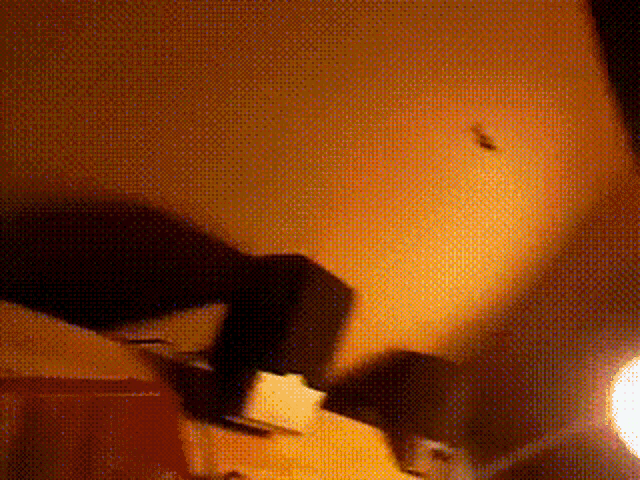 a blurred image of a person laying on a bed in a room
