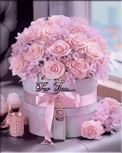a bouquet of pink roses in a box with the words for you written on the bottom