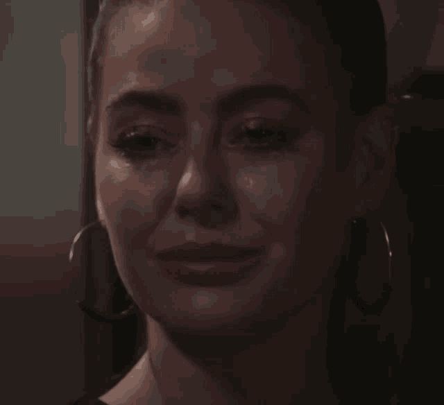 a close up of a woman 's face with a tear running down her cheek