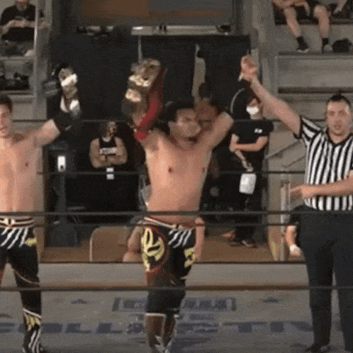a wrestler is holding a championship belt in his hand