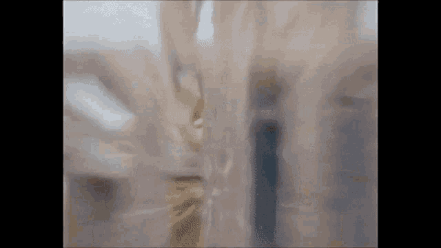 a blurry picture of a person behind a curtain