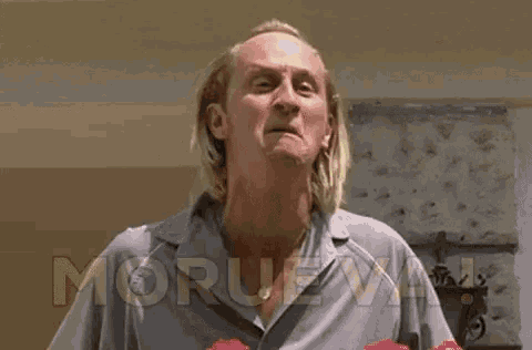 a man with long hair and a beard is making a face and the words morue va are above him