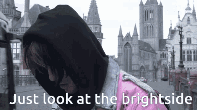 a man in a black hoodie is standing in front of a castle with the words just look at the brightside below him