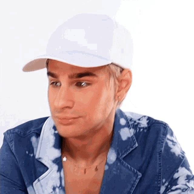 a man wearing a white hat and tie dye jacket
