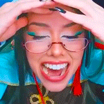 a woman wearing glasses is smiling with her hands on her head