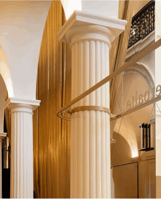 a building with columns and a sign that says ellsone on it