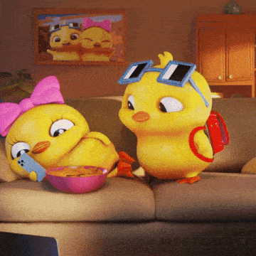 two cartoon ducks are sitting on a couch with a bowl of chips