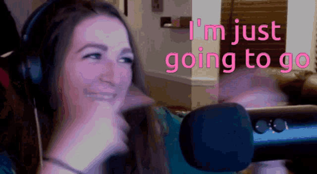 a woman wearing headphones says " i 'm just going to go " in pink letters