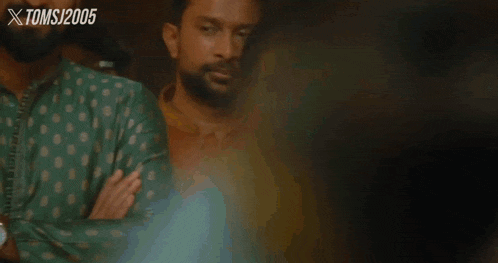 a woman in a sari smiles in front of a toms 2005 ad