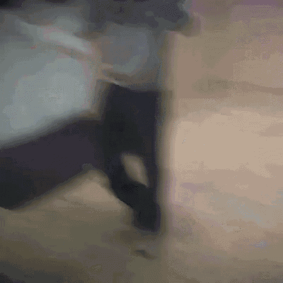 a blurry photo of a person walking on a wooden floor