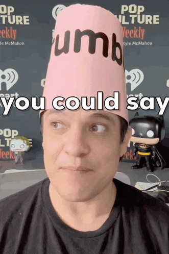a man wearing a pink hat that says " you could say " on it