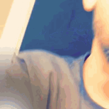 a close up of a person 's face with a blue shirt on