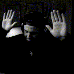 a black and white photo of a man with his hands up in the air