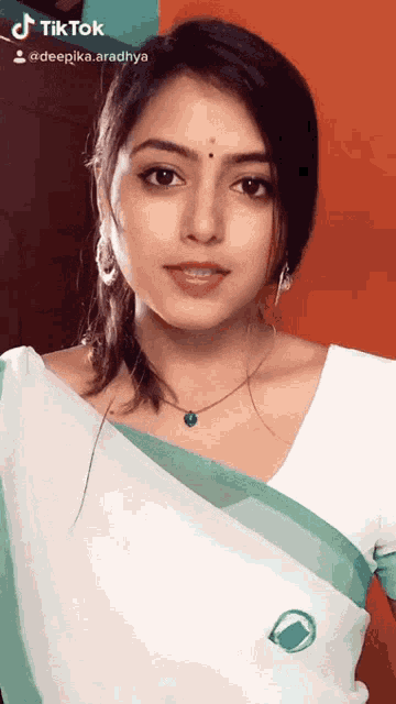 a tiktok video of a woman in a white top