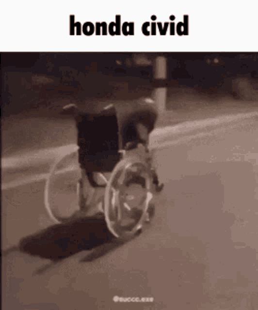 a person in a wheelchair is driving down a road .