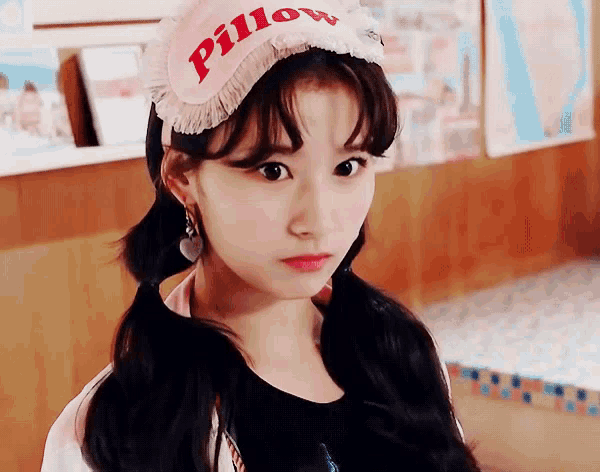 a young woman wearing a pink pillow hat