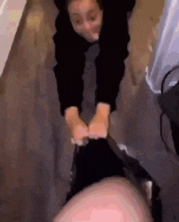 a woman is putting her feet on a man 's face .