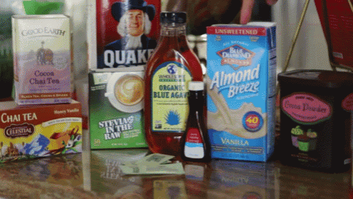 a box of almond breeze sits on a counter next to a box of quaker oats