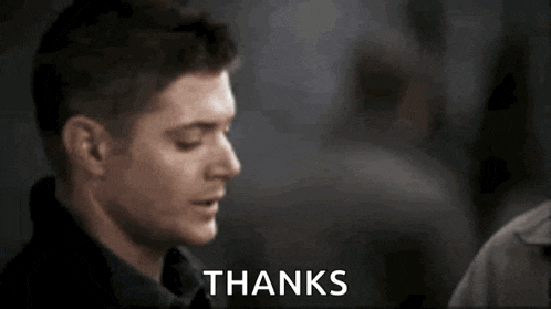 a close up of a man 's face with the words `` thanks '' written in the background .