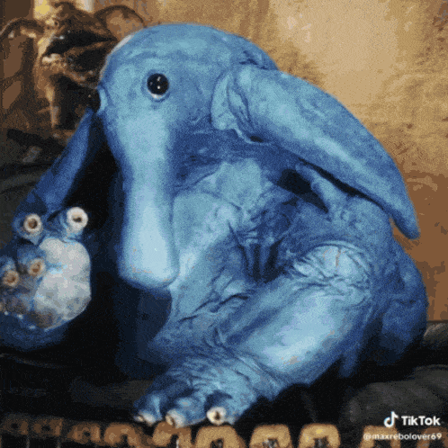 a blue stuffed animal with a tiktok watermark on the bottom right corner