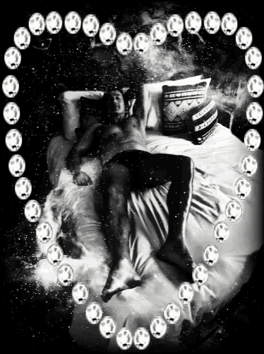 a black and white photo of a person laying on a bed surrounded by smiley faces