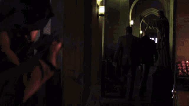 a blurry picture of a person in a dark room with a purple light behind them