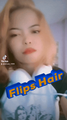 a woman is wearing headphones and has the words flips hair on her face