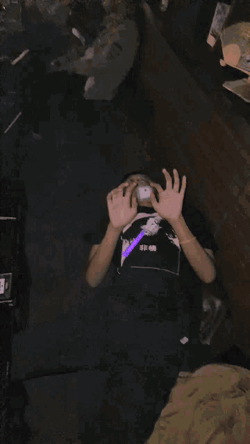 a person with a bandage on their face is wearing a black shirt with a picture of a man on it