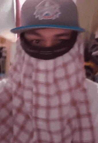 a man wearing a hat with a miami dolphins logo on it