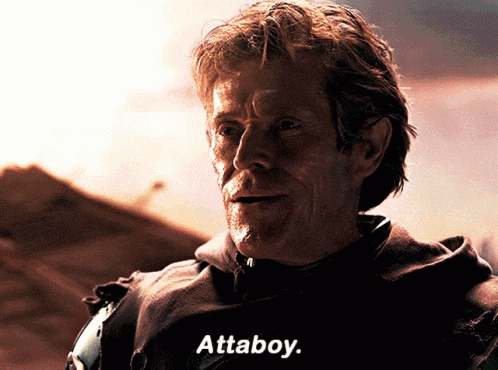 a close up of a man with the words attaboy on the bottom