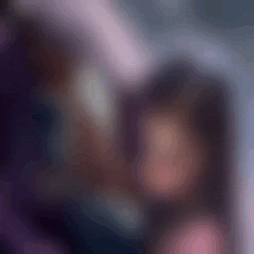 a blurry picture of a man and a woman looking at each other