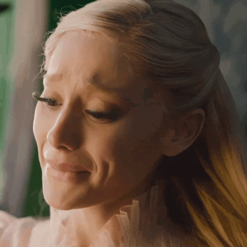 a woman with a tattoo on her forehead is crying