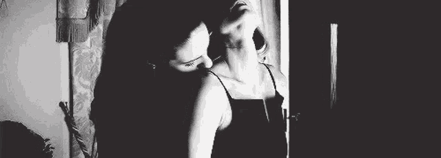 two women are having sex in a black and white photo .