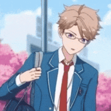 a boy in a blue suit and red tie is walking with a backpack .