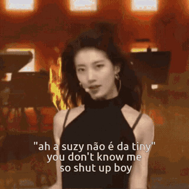 a woman in a black dress says " ah a suzy nao e da tiny you don t know me so shut up boy "