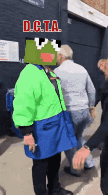 a man in a green and blue jacket with the word d.c.t.a.
