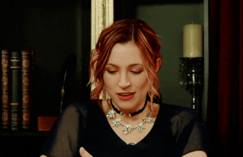a woman says so the plan is in front of a book shelf