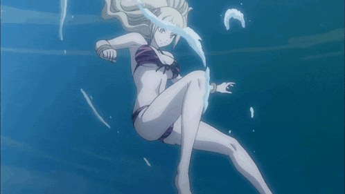 a woman in a bikini is swimming underwater