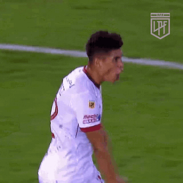 two soccer players are hugging each other on a field