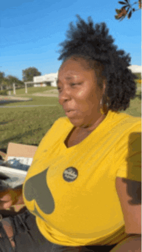 a woman wearing a yellow shirt with a nike logo on the front