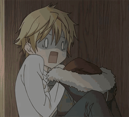 a boy with a surprised look on his face is sitting on the floor