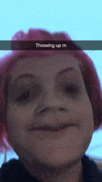 a girl with red hair is throwing up a meme